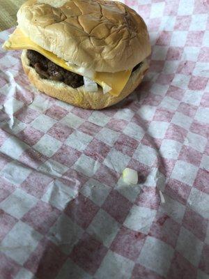 Cheeseburger with mustard, slaw and onions.