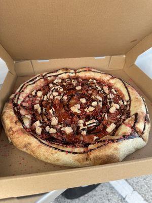 Desert pizza with strawberries, wafers, and chocolate syrup