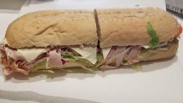 Delicious turkey sub with lettuce, tomato, cheese, onion, mayo, and sandwich dressing.