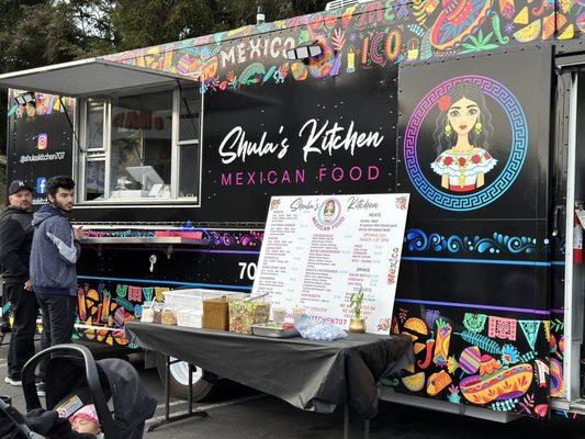 Front of food truck, salsas and menu showing