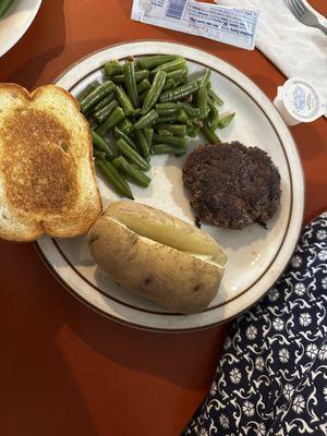 Hamburger steak with baked potato, green beans and Texas toast