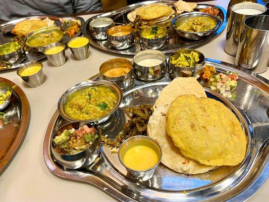 Thali way!  Mini buffet that comes to you of Indian curries/sauces around the rice and sides on individual round metal platters