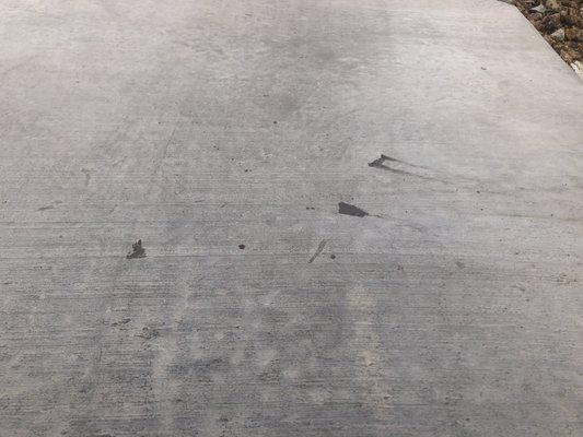 Drips and smears of epoxy on exterior driveway. These can not be removed.