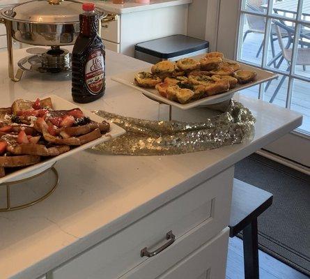 French toast with berries and powdered sugar along with Frittatas