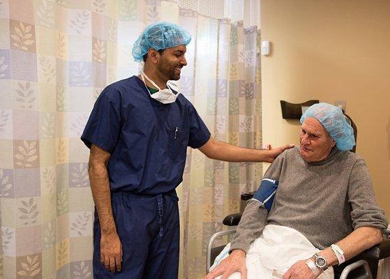 Dr. Samir Vira, M.D. with patient post cataract surgery.