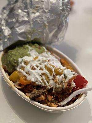 Loaded spicy pork bowl! Added grilled veggies and guac.