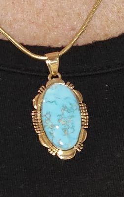 Turquoise pendant set in gold.