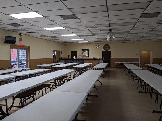 VFW 3500 - Hall rental looking from the side door to the front. Loads of tables to be set up. Restrooms to the right.