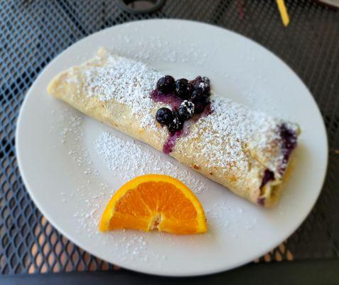 Huge and superb gluten free blueberry crepe stuffed full with large blueberries, creme cheese and covered with powdered sugar....