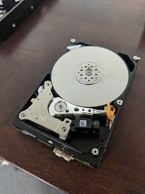 NEVER allow anyone to remove your hard drive cover - exposing the drive to air damages your chances of recovery.