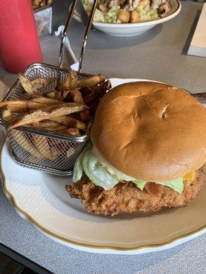 chicken sandwich with fries and ceasar salad