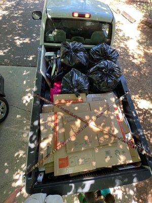 Here is the e organized trash. 4 trash bags, and a small bin of metal in the first half of an 8' bed, and cardboard in the other half.