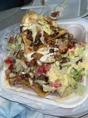 Chicken, steak and shrimp nachos supreme