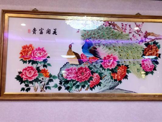 The peacocks and flowers in the painting are gorgeous.