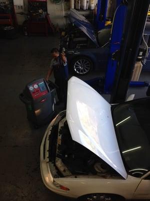 Ruben working on a/c check on a vehicle.