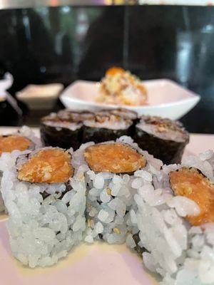 Spicy salmon roll front, eel roll back and cucumber salad