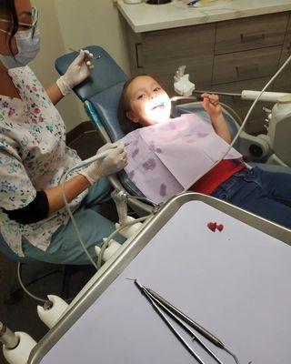 4 1/2 year old girl having fun at the dentist.