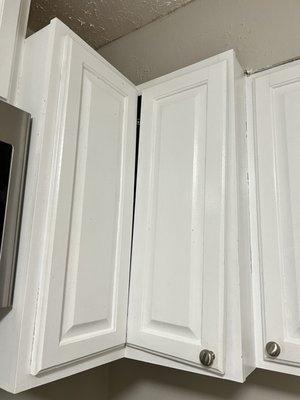 2 crooked kitchen cabinets. The person that did this work was either blind or completely careless