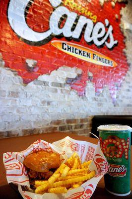 The Sandwich Combo: 3 chicken fingers, Cane's Sauce, lettuce, toasted bun; crinkle-cut fries, 22oz fountain drink / tea ($9.99).