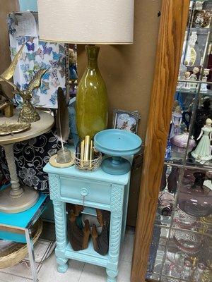 Telephone table, MCM lamp, brass eagles, and wooden carvings.