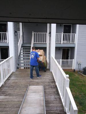 Joshua Meeks unloading boxes at the customers new apartment