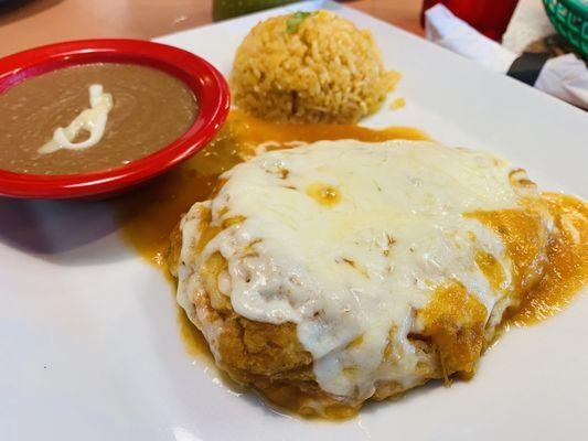 Stuffed mozzarella cheese Chile relleno served with fluffy rice and refried beans