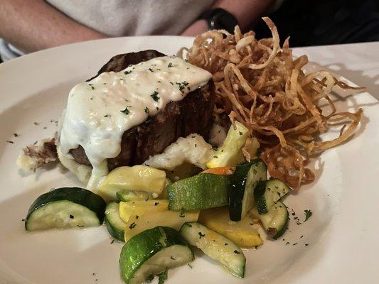 Filet on mashed potatoes and shoestring onions w/ veggies