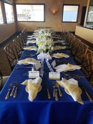 Two tables with two 90"x156" royal blue taffeta tablecloths.