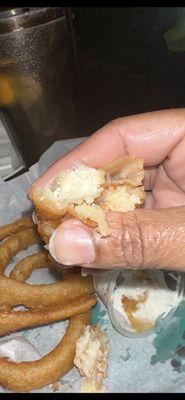 A close-up of the uncooked interior of the raw onion ring.