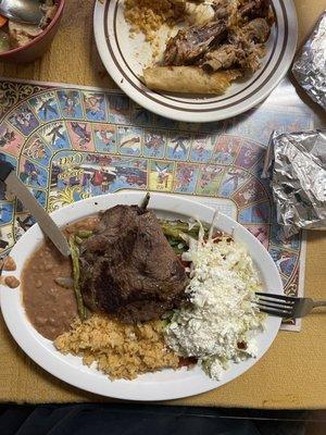 I plate of buffet and a plate of carne asada with enchiladas