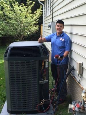 Comfortable Air Services Technician installing a TRANE 18 SEER AC Unit.