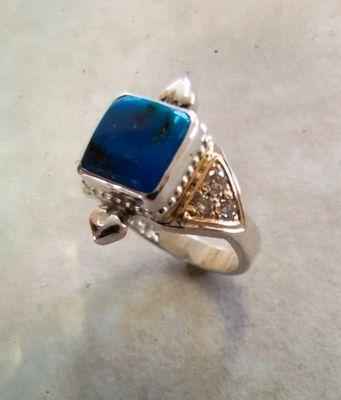 Sterling Silver and 14k gold with Turquoise and Diamonds.  Thanks Clifford TBRD