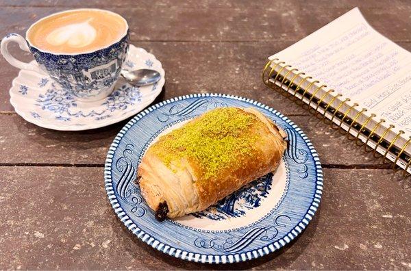 Pistachio and chocolate croissant and a cappuccino