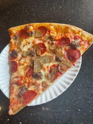 Meat lovers pizza slice