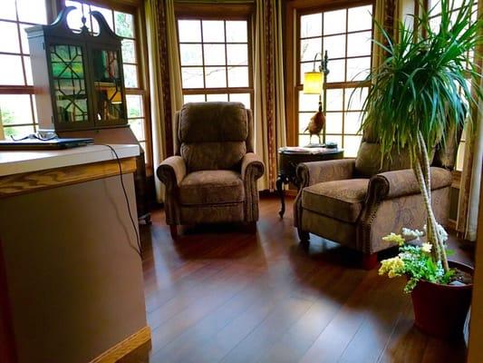 Sunroom transformed into an elegant retreat through the addition of bamboo flooring.