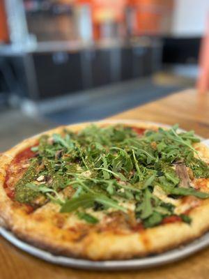 Sausage, mushroom & spinach topped with arugula and pesto drizzle