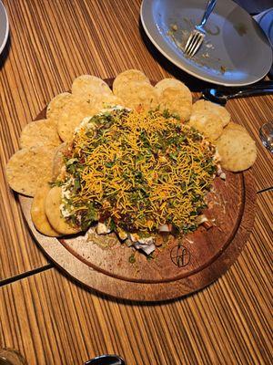 Papdi Chaat - Crispy fried dough wafers topped with potatoes, yogurt, and chutneys