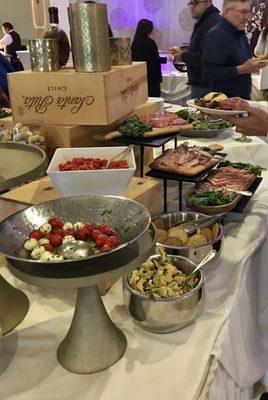 Food bars set up during the Mother's Day brunch event - each table catered specialties like appetizers, meats, entrees, etc