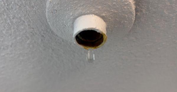 Yellow water dropped down from above unit bathroom