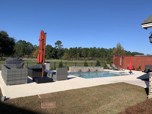 Modern style pool with seating area