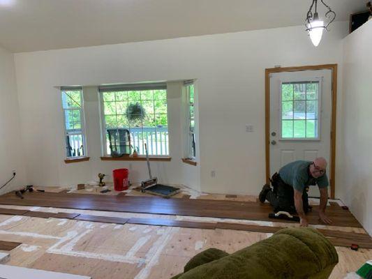 Laying laminate flooring for client.