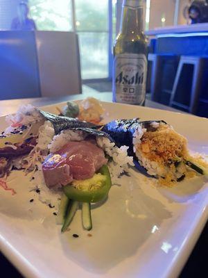 Left to right Salmon skin roll, yellowtail, and spicy scallop