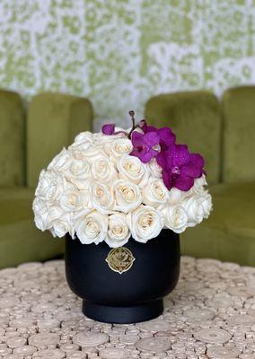 60 roses, Orchids in a ceramic vase. 
Also available in large size- up to 105 roses.