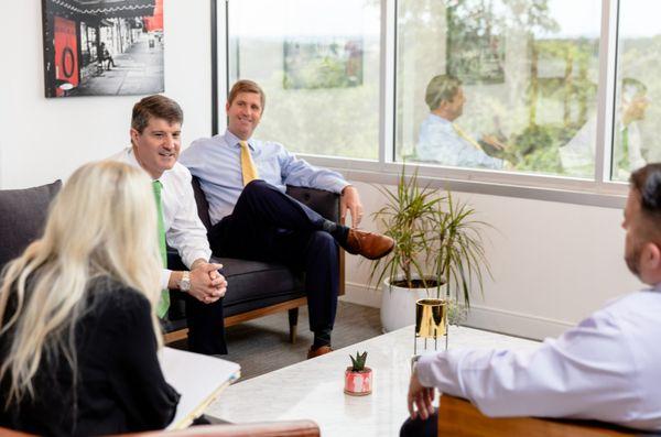 Graham Sutliff & Hank Stout meet with their staff members in one of the Sutfliff & Stout offices.