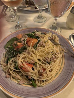 Spaghetti with sausage broccoli rabe and tomatoes.