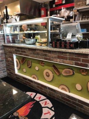 The front counter showing the wood that fires the oven