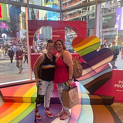 The wife and I on T-Mobile Tuesday in Time Square posing with the T-Mobile Pride Display ‍