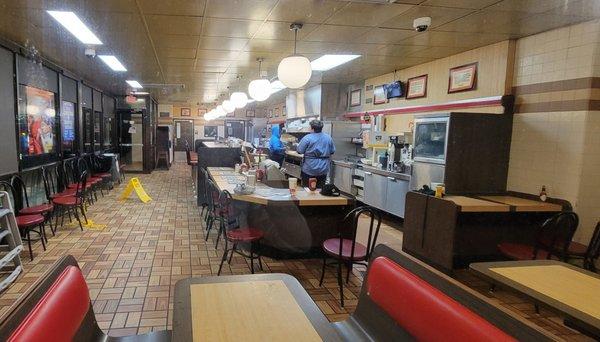 The staff just standing behind the counter doing nothing with their belongings all over the counter.