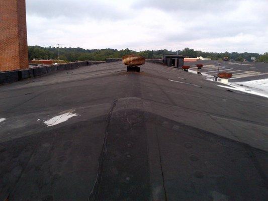 EPDM Roof before Silicone Coating - Leaking at the seams and throughout the roof.