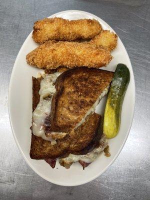 House made pastrami sandwich with onion chutney and potato croquettes.